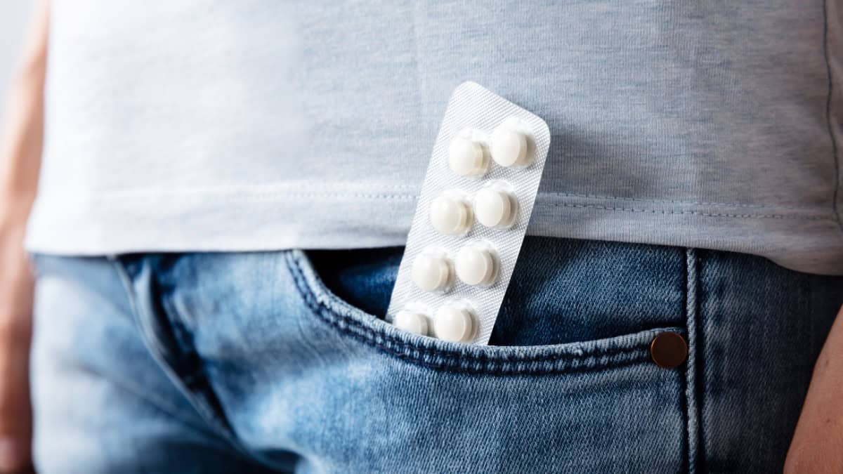 Close-up of white pills in a pocket